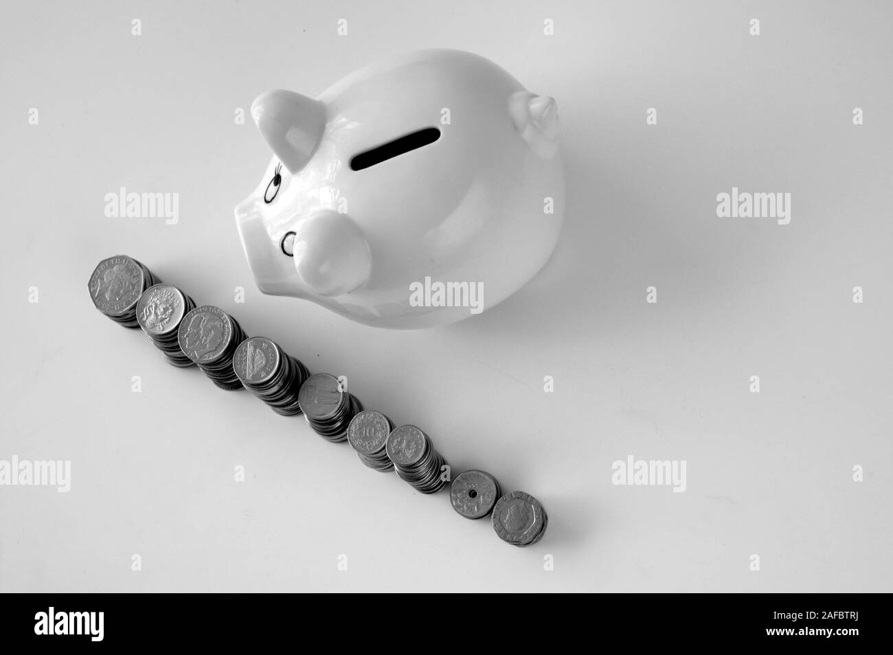 Piggy bank with stack of coin on white Stock Photo - Alamy
