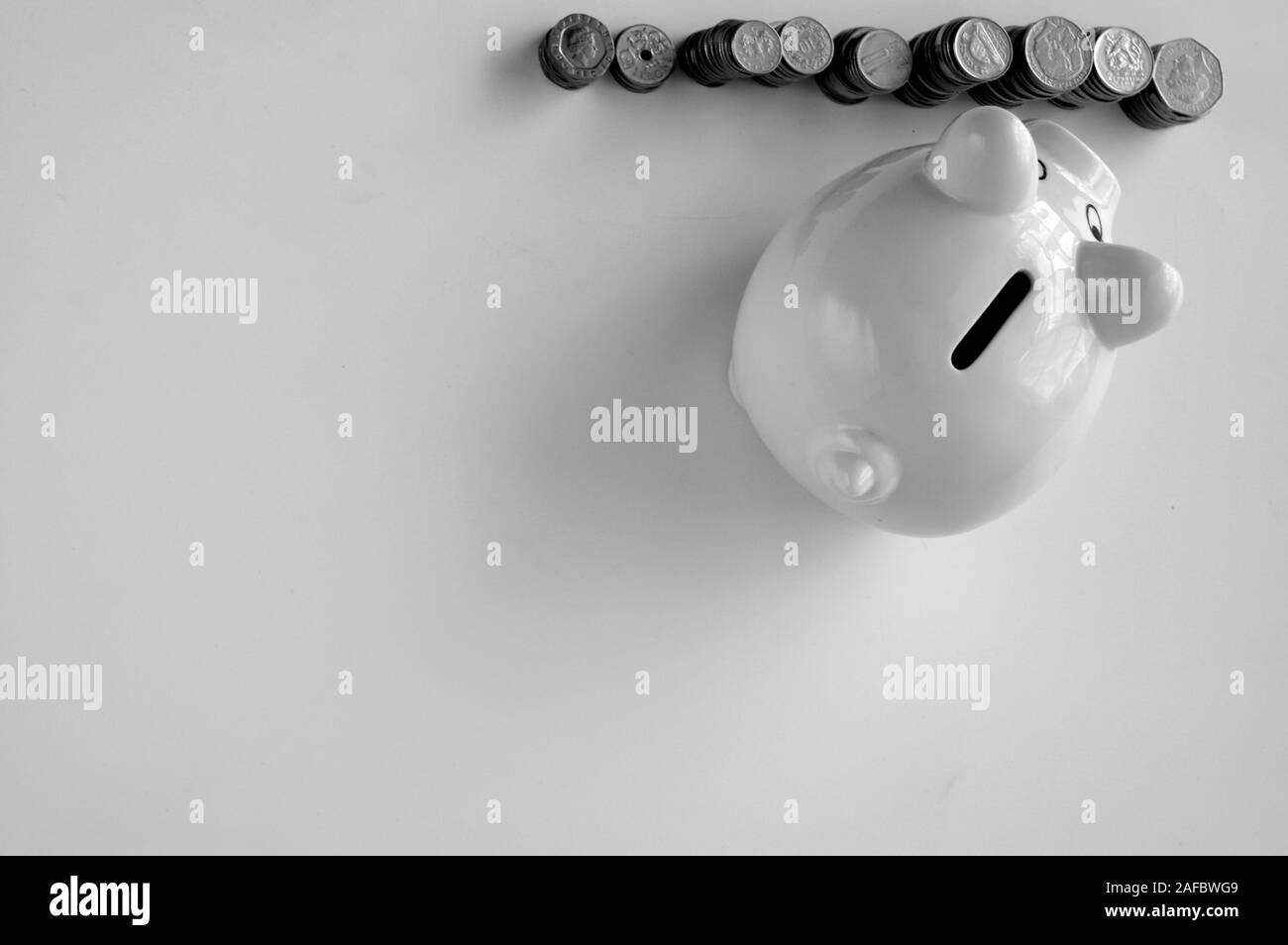 Piggy bank with stack of coin on white Stock Photo - Alamy