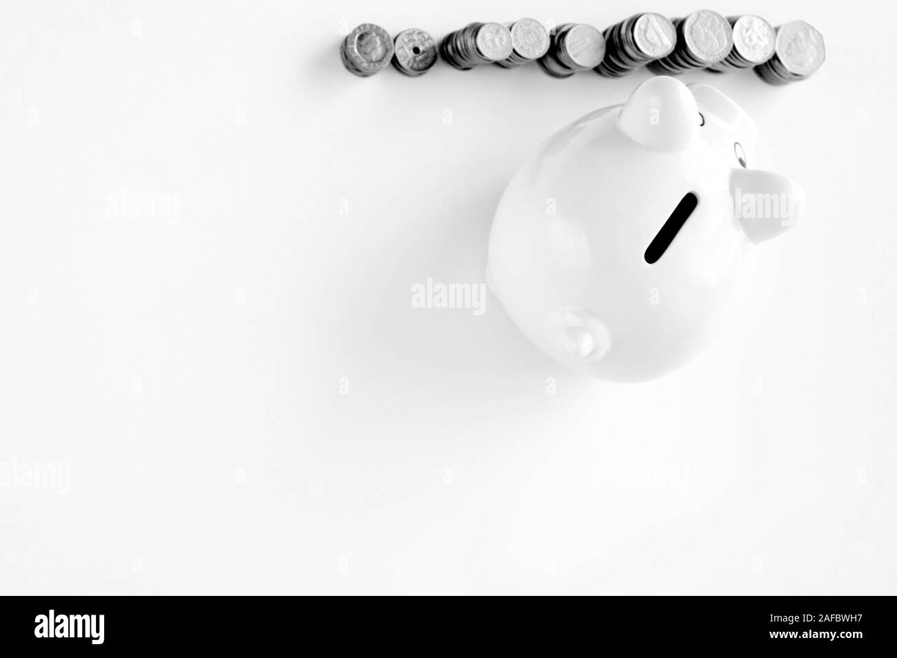 Piggy bank with stack of coin on white Stock Photo - Alamy