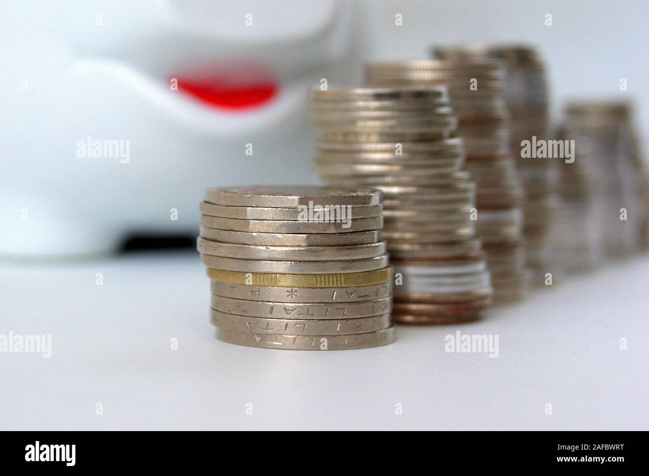 Piggy bank with stack of coin on white Stock Photo - Alamy