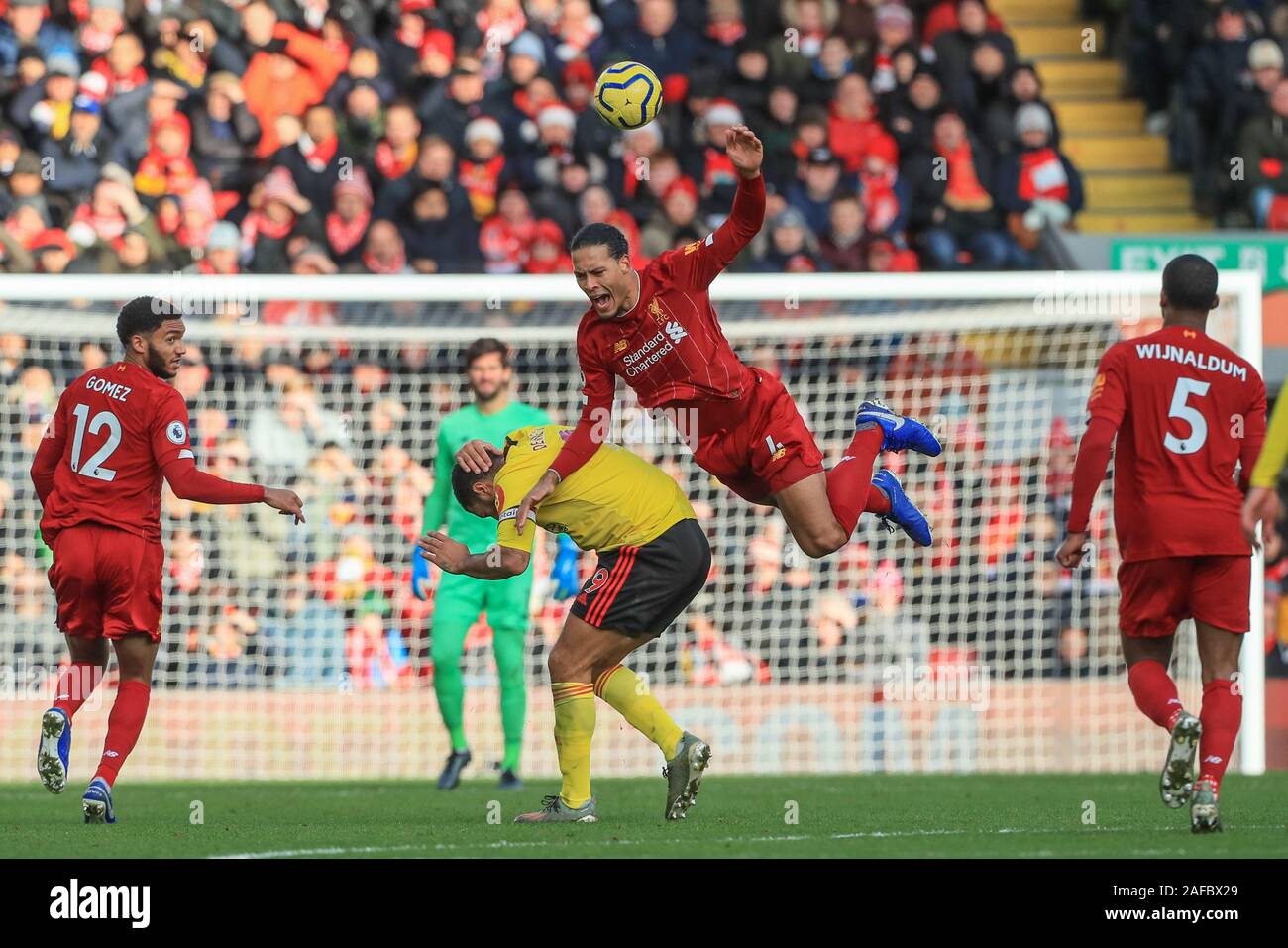 14th December 2019, Anfield, Liverpool, England; Premier League, Liverpool  v Watford : Virgil van Dijk (4) of Liverpool and Troy Deeney (9) of Watford  dual for the ball Credit: Mark Cosgrove/News Images