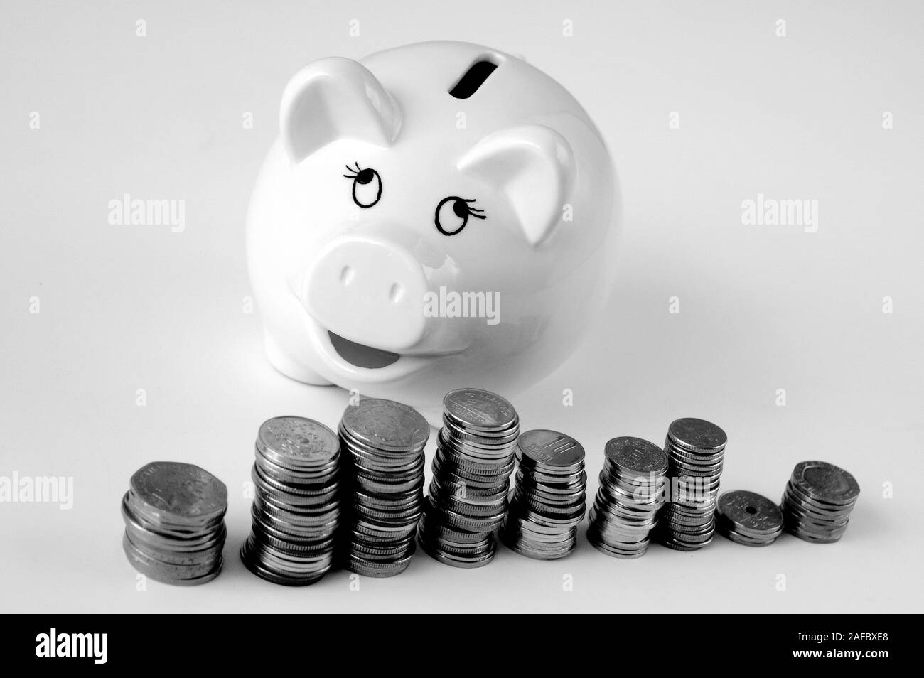 Piggy bank with stack of coin on white Stock Photo - Alamy