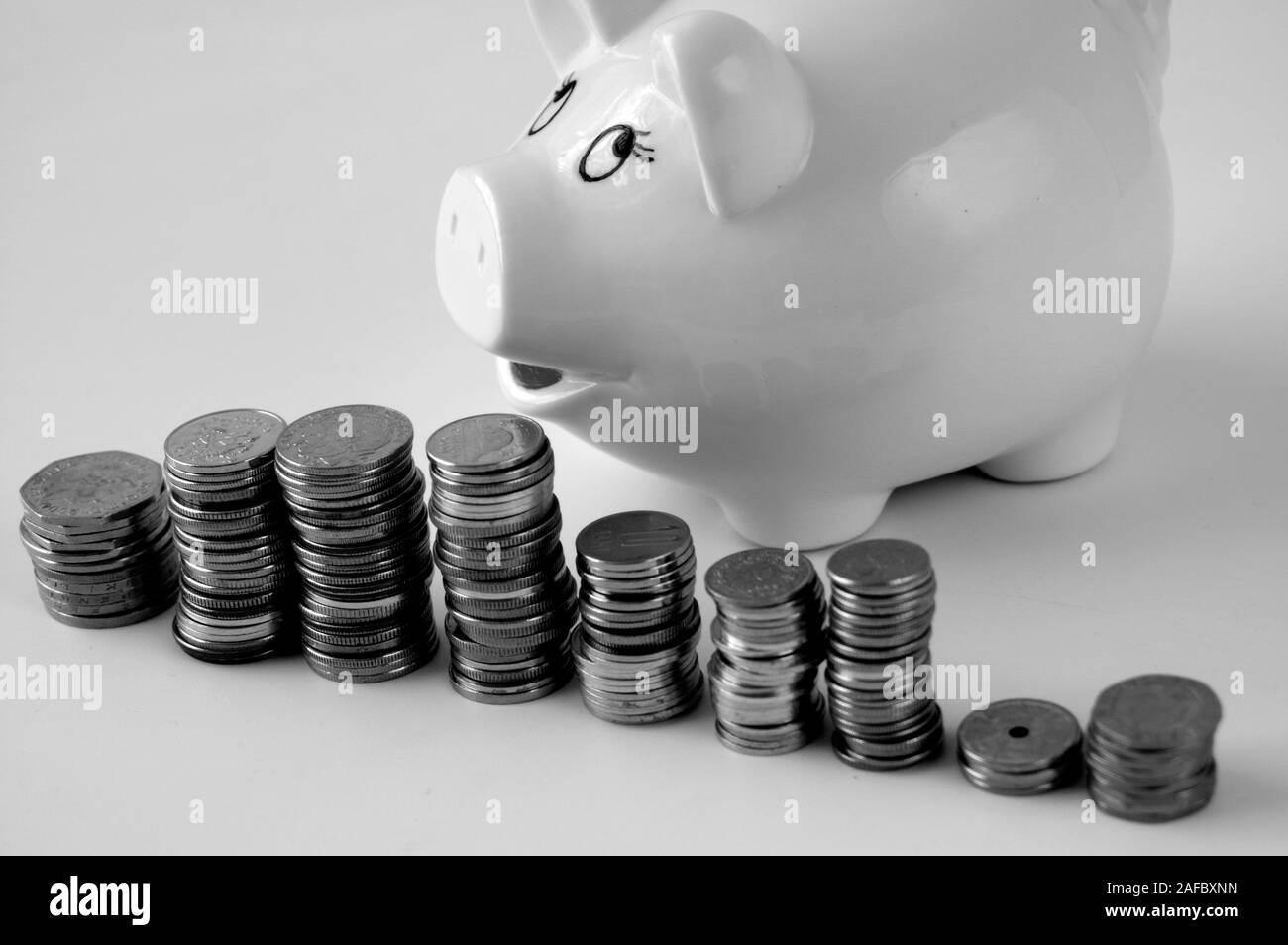 Piggy bank with stack of coin on white Stock Photo - Alamy