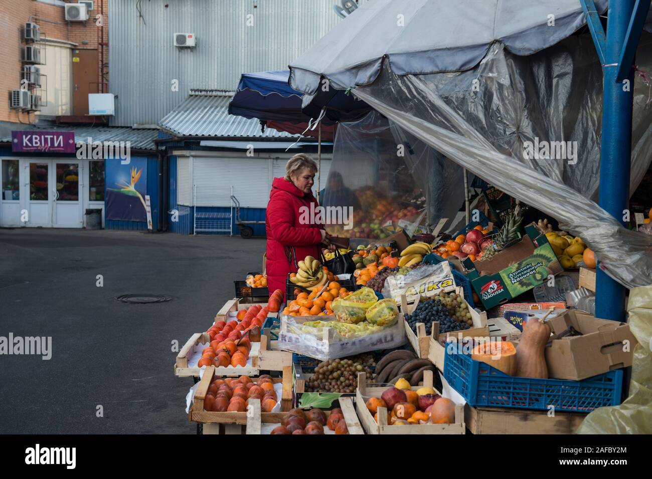 A woman buying fruits and vegetables on the market at Livoberezhnyi Masyv, Kiev, Ukraine, Eastern Europe. Stock Photo