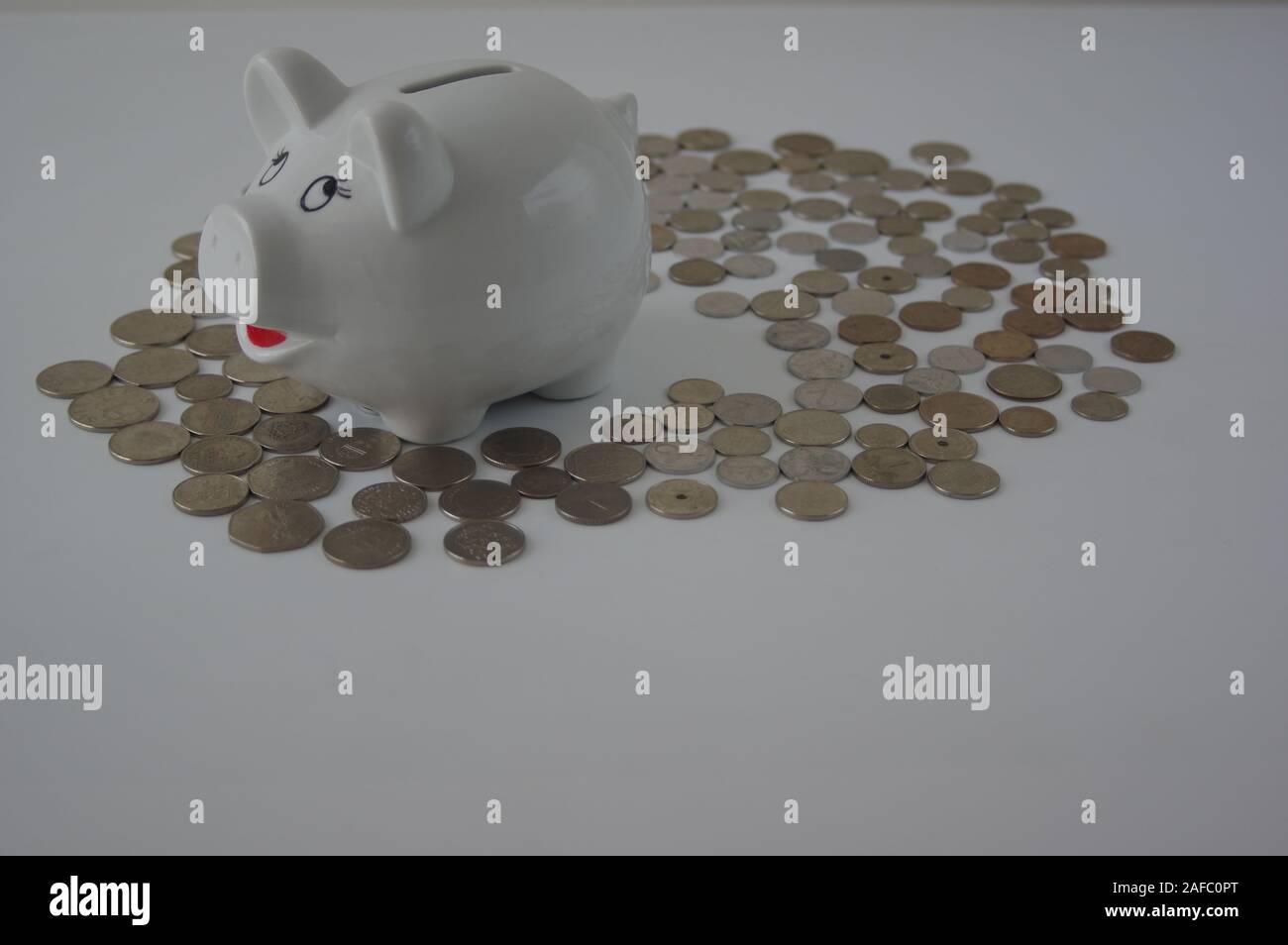 Piggy bank with stack of coin on white Stock Photo - Alamy