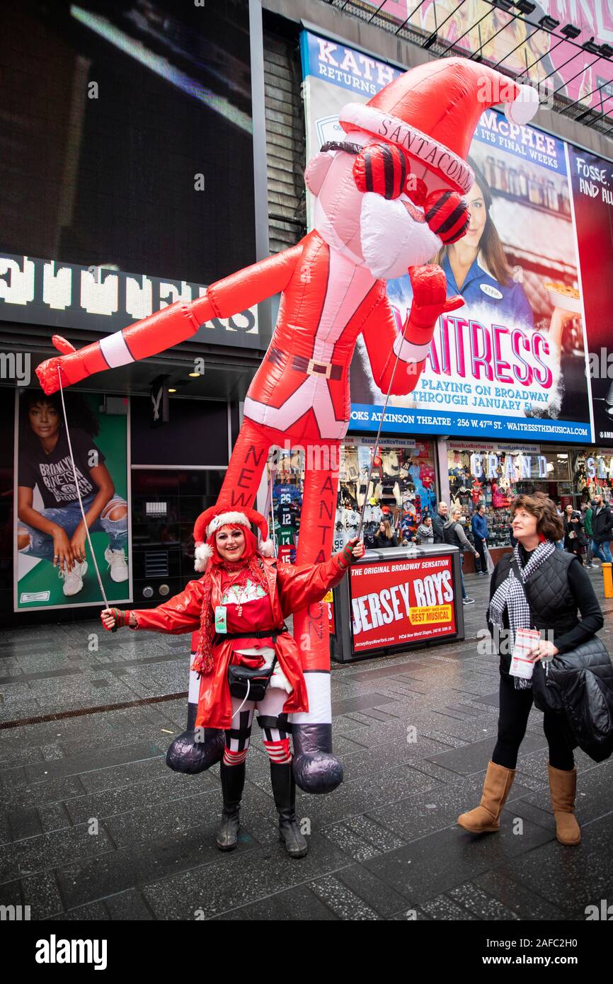 New York, USA. 14th Dec, 2019. People attend the 2019 SantaCon in New York, the United States, Dec. 14, 2019. Dressed in Santa Claus or festive costumes, hundreds of People gathered at Times Square for the 2019 SantaCon on Saturday, enjoying the Christmas atmosphere and raising money for charity. Credit: Wang Ying/Xinhua/Alamy Live News Stock Photo