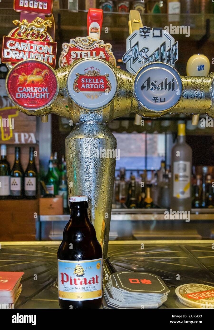 Melbourne, Australia - December 17, 2009: Cookie Thai eatery and beer hall. Closeup of third tap with Belgian IPA Piraat bottle in front. Back is a fa Stock Photo