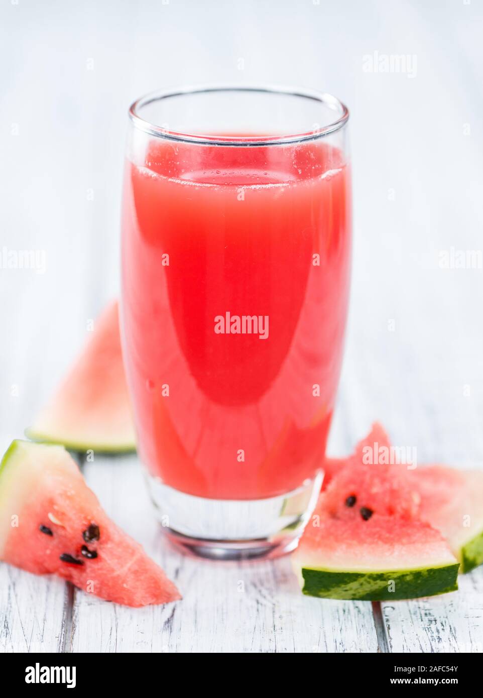 Homemade Watermelon Smoothie on an wooden table (selective focus) as detailed close-up shot Stock Photo