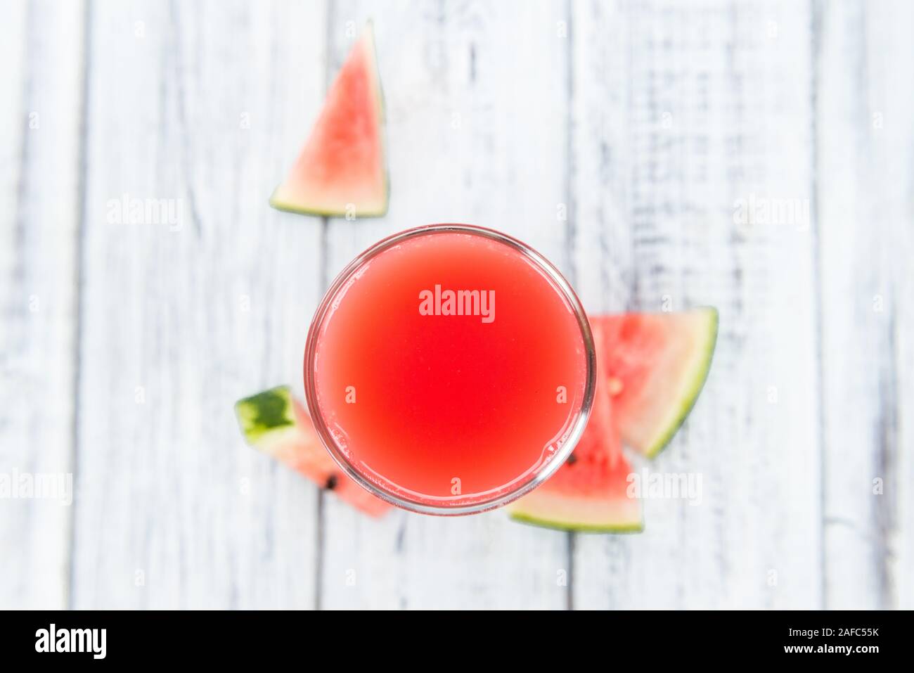 Homemade Watermelon Smoothie on an wooden table (selective focus) as detailed close-up shot Stock Photo