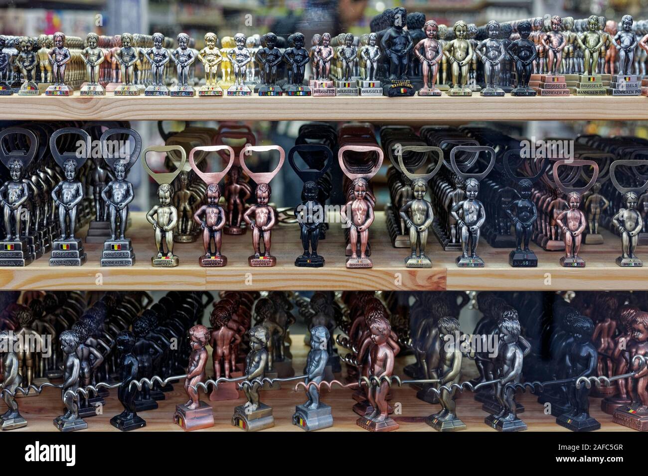 Small Manneken Pis figures as bottle openers and corkscrews in display in shop window, souvenir, Brussels, Belgium Stock Photo