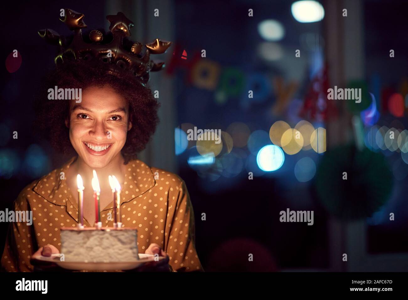 Pretty smiling birthday girl holding birthday cake Stock Photo - Alamy