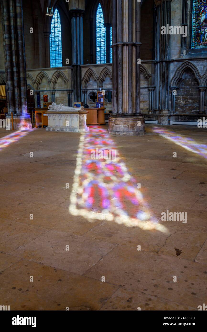 Sunlight through stained glass windows in forming a colourful pattern