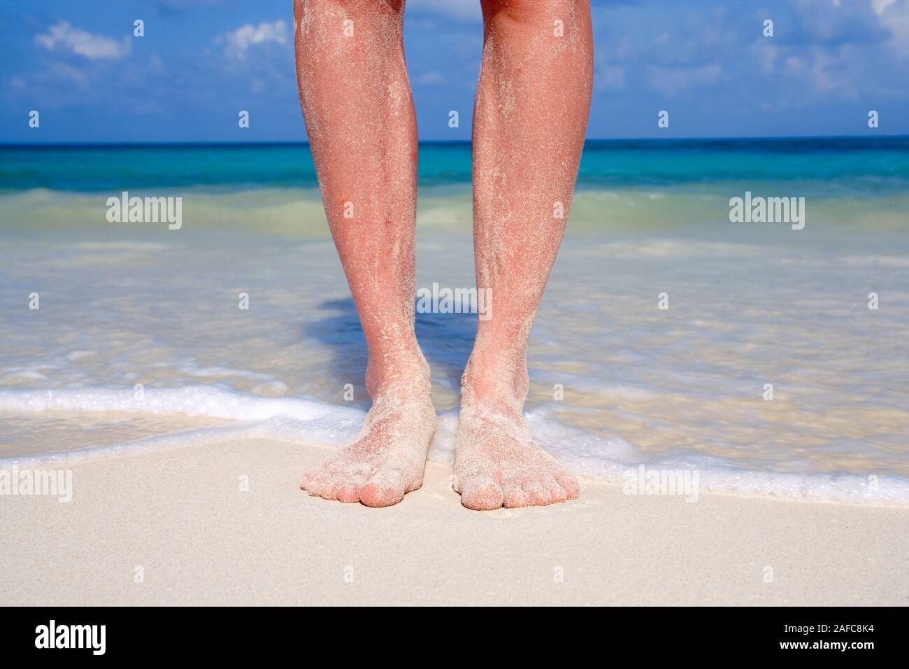 Womans feet covered with sand on tropical beach in Playa del Carmen, Mexico Model Released Photo Stock Photo