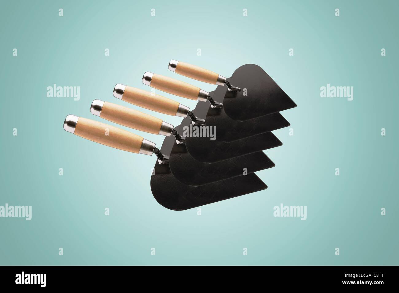 collection of construction spatulas over light blue background, tools