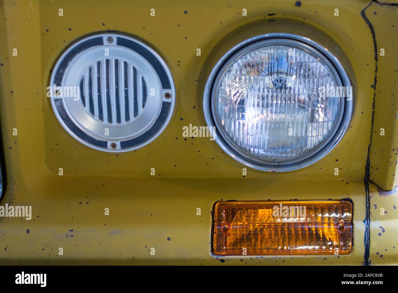 Old yellow truck vintage headlights blinker Stock Photo