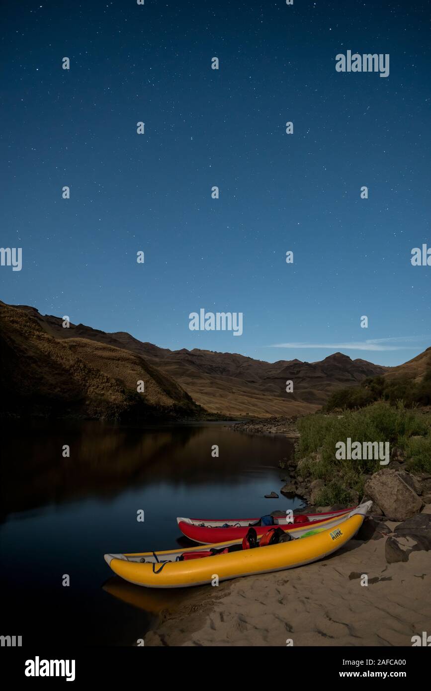 Inflatable kayaks tied up for the night at a campsite on the Lower Salmon River in Idaho. Stock Photo