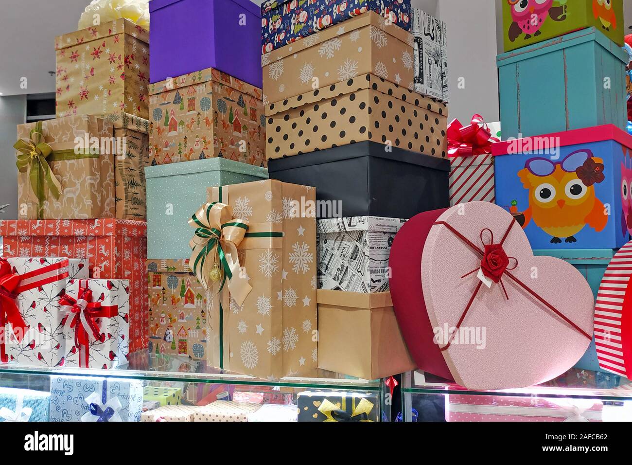 Multicolored Gift Boxes With Bows In The Mall Paper Boxes For Decorating Christmas Presents Many Gift Boxes Stand On Top Of Each Other Stock Photo Alamy