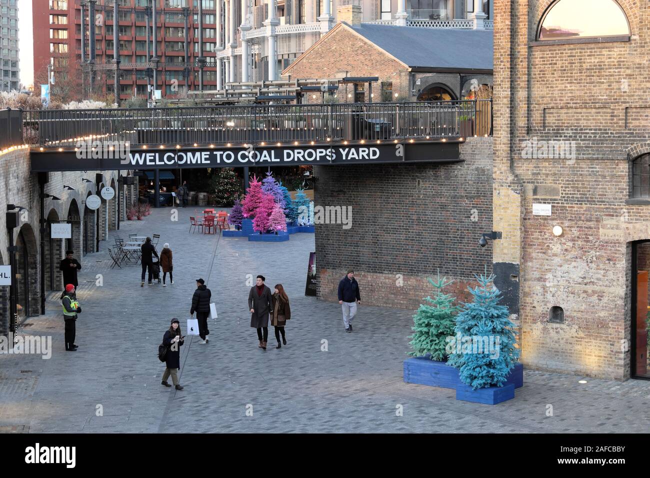 Welcome to Coal Drops Yard shopping centre and shoppers at Christmas in Kings Cross area of Camden London England UK  KATHY DEWITT Stock Photo
