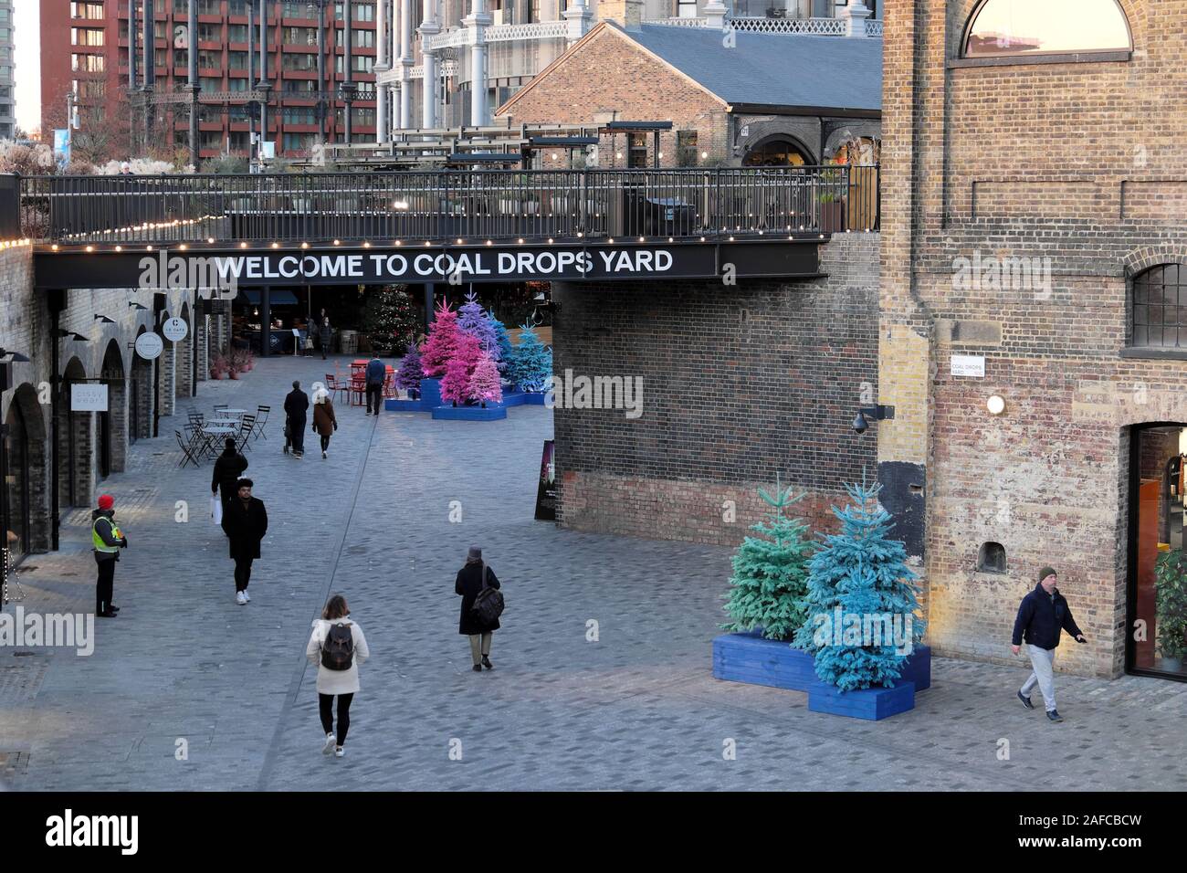 Welcome to Coal Drops Yard shopping centre and shoppers at Christmas in Kings Cross area of Camden London England UK  KATHY DEWITT Stock Photo