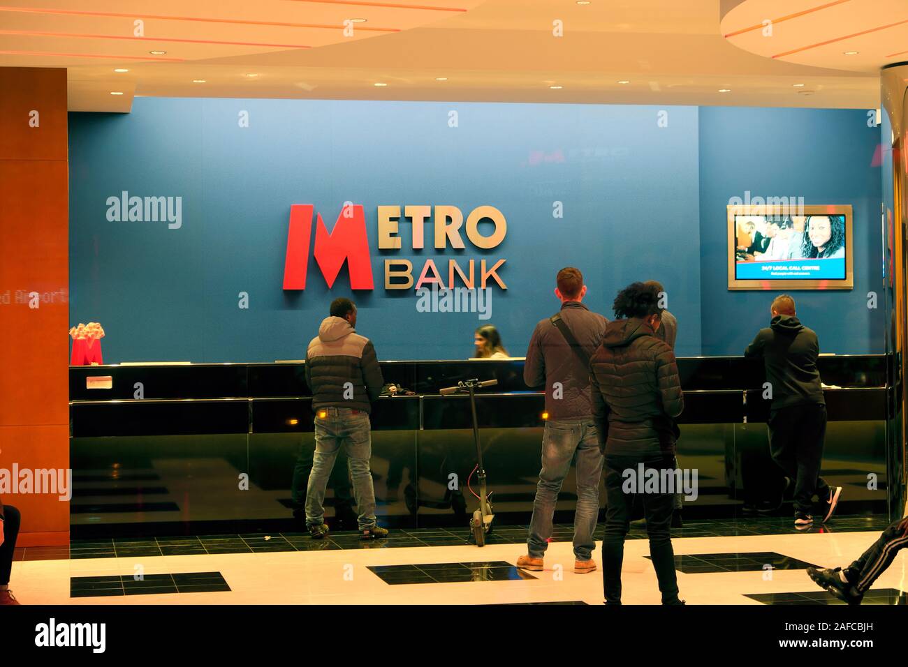 Customers queuing people queue at counter inside Metro Bank interior in City of London England UK  KATHY DEWITT Stock Photo