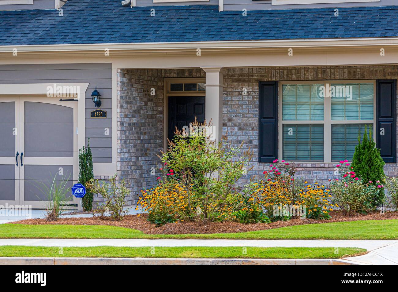 Nice Brick Townhouse with Security Sign Stock Photo