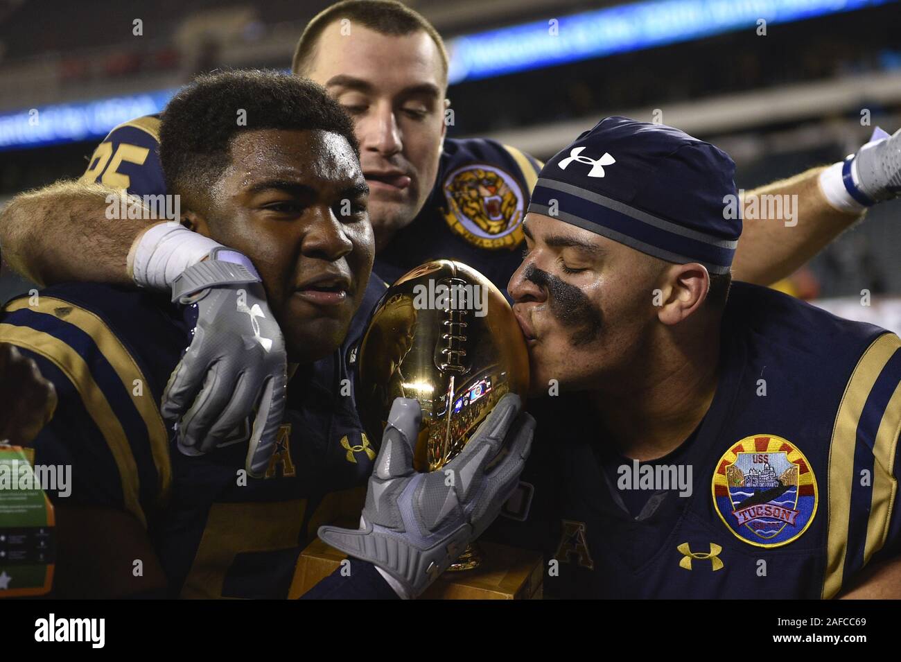 Philadelphia, USA. 14th Dec, 2019. Navy Midshipmen celebrate with the secretary's trophy after a victory against the Army Black Knights at Lincoln Financial Field in Philadelphia on Saturday, December 14, 2019. Navy won 31-7. Photo by Derik Hamilton/UPI Credit: UPI/Alamy Live News Stock Photo