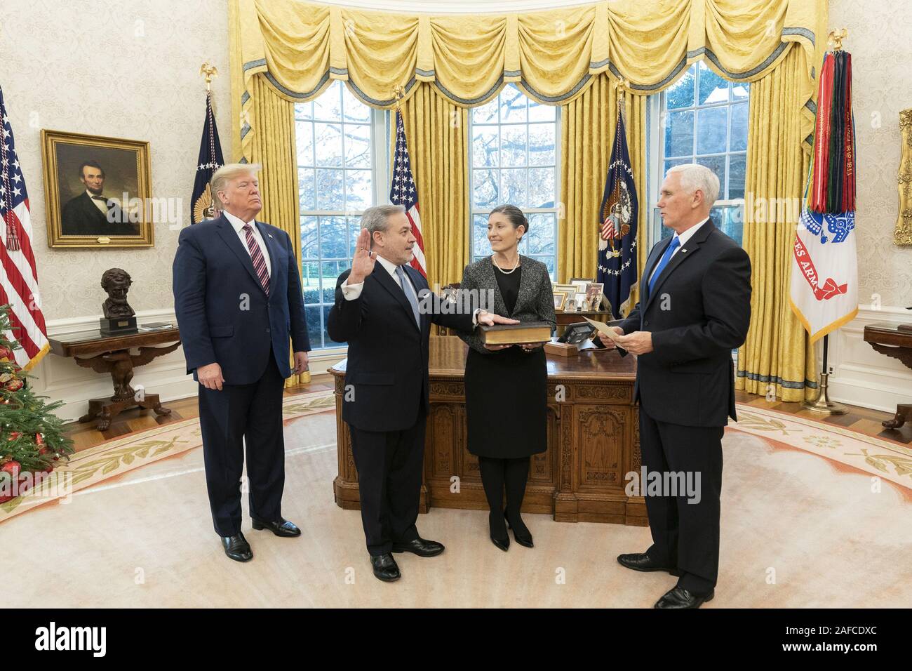 Washington, United States Of America. 11th Dec, 2019. President Donald J. Trump and Adrienne Brouillette look on as Vice President Mike Pence swears in Secretary of Energy Dan Brouillette Wednesday, Dec. 11, 2019, in the Oval Office of the White House. People: President Donald J. Trump, Dan Brouillette Credit: Storms Media Group/Alamy Live News Stock Photo