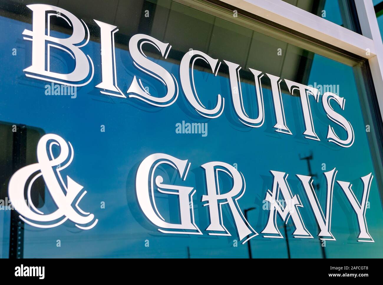 A sign on a window advertises biscuits and gravy at Metro Diner, July 29, 2018, in Huntsville, Alabama. Stock Photo