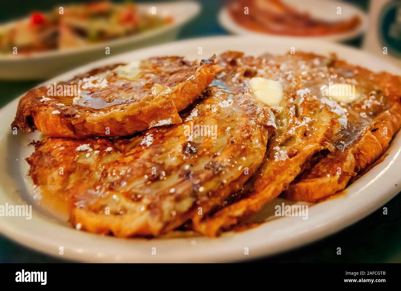 Croissant French Toast is paired with bacon and hashbrowns for breakfast at Metro Diner, July 29, 2018, in Huntsville, Alabama. Stock Photo