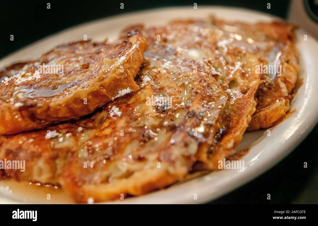 Croissant French Toast, covered in syrup and powdered sugar, is served for breakfast at Metro Diner, July 29, 2018, in Huntsville, Alabama. Stock Photo