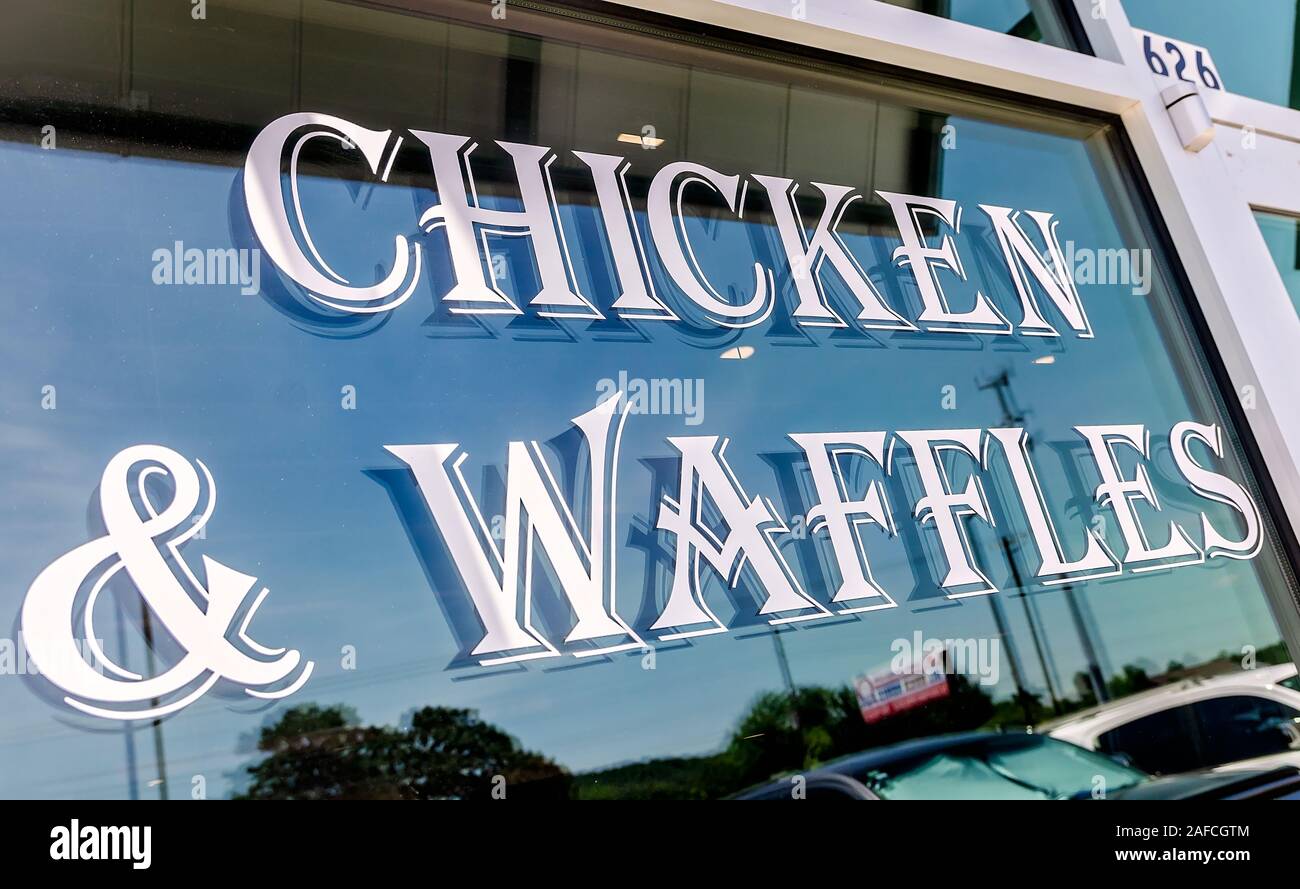 A sign on a window advertises chicken and waffles at Metro Diner, July 29, 2018, in Huntsville, Alabama. Stock Photo