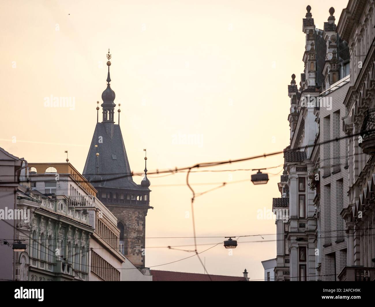 Picture of the iconic belfry tower of the New Town Hall (novomestska radnice) of Prague, Czech Republic, surrounded by narrow touristic medieval stree Stock Photo