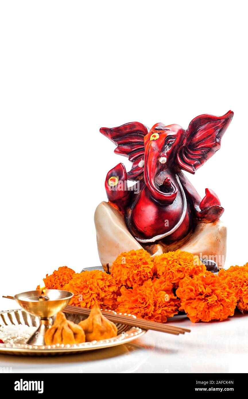 Hindu God Ganesha. Statue of Lord Ganesha. Worship (Pooja) arrangement on white background Stock
