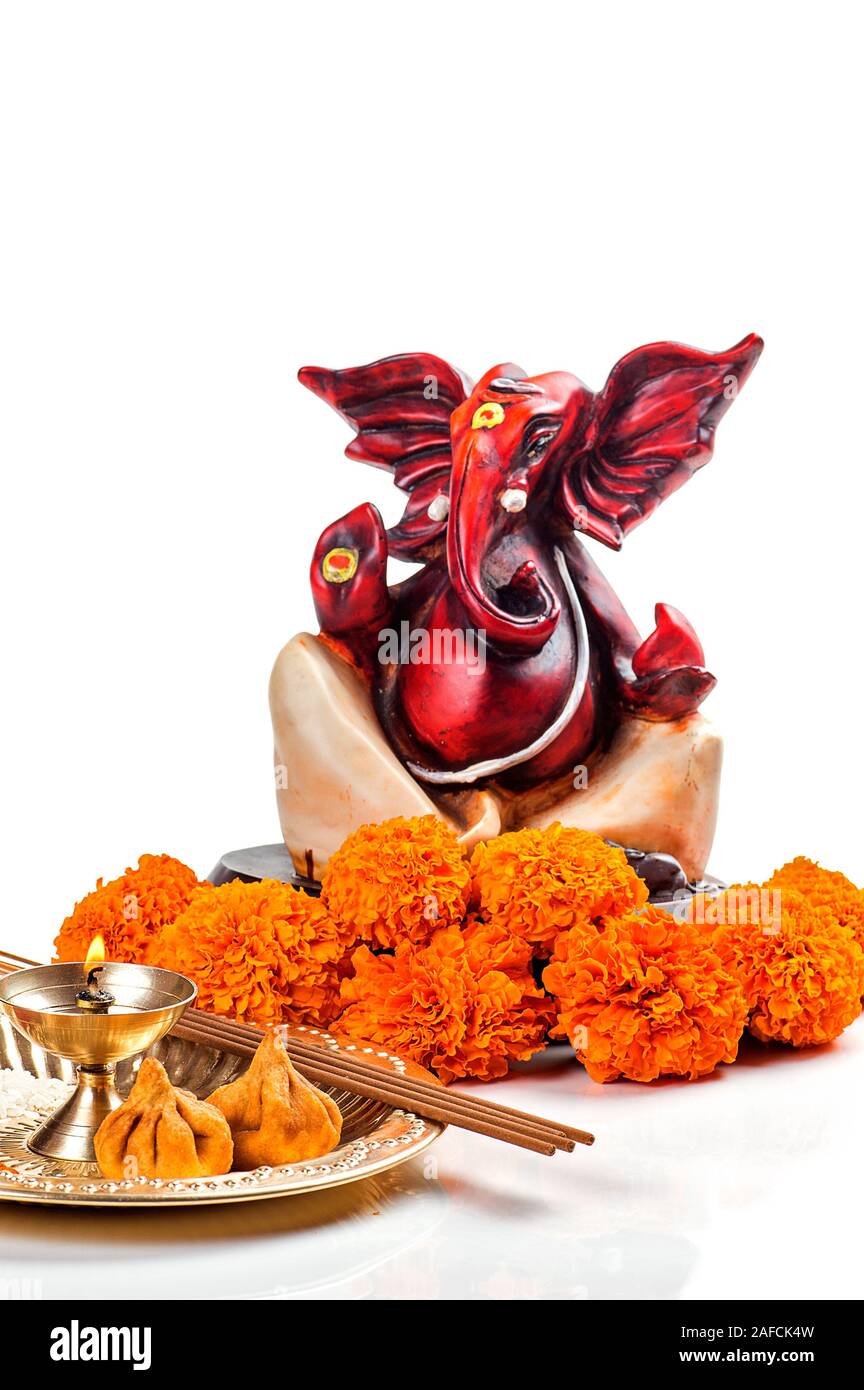 Hindu God Ganesha. Statue of Lord Ganesha. Worship (Pooja) arrangement on white background Stock