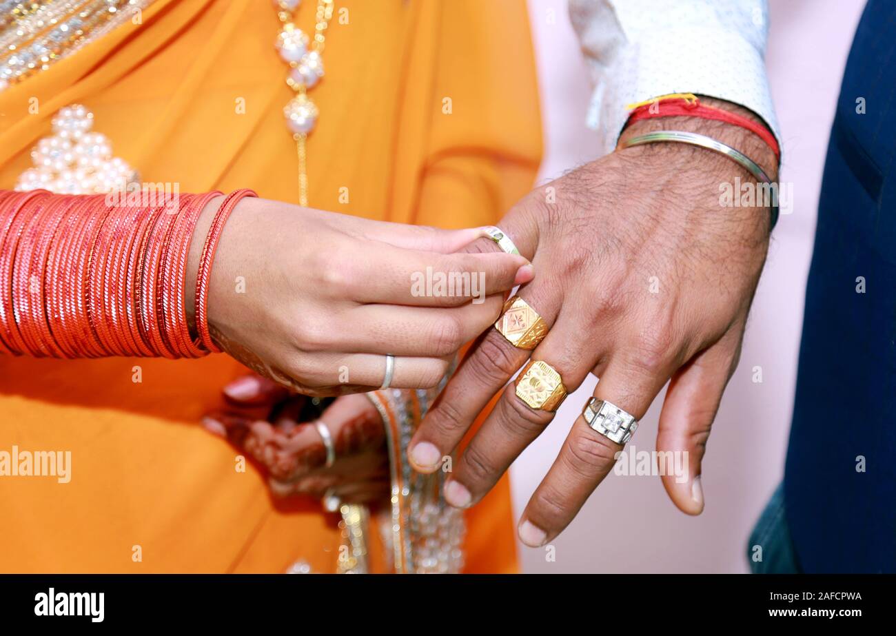 Premium Photo | The bride and groom are exchanging wedding rings in the ring  ceremony in indian wedding
