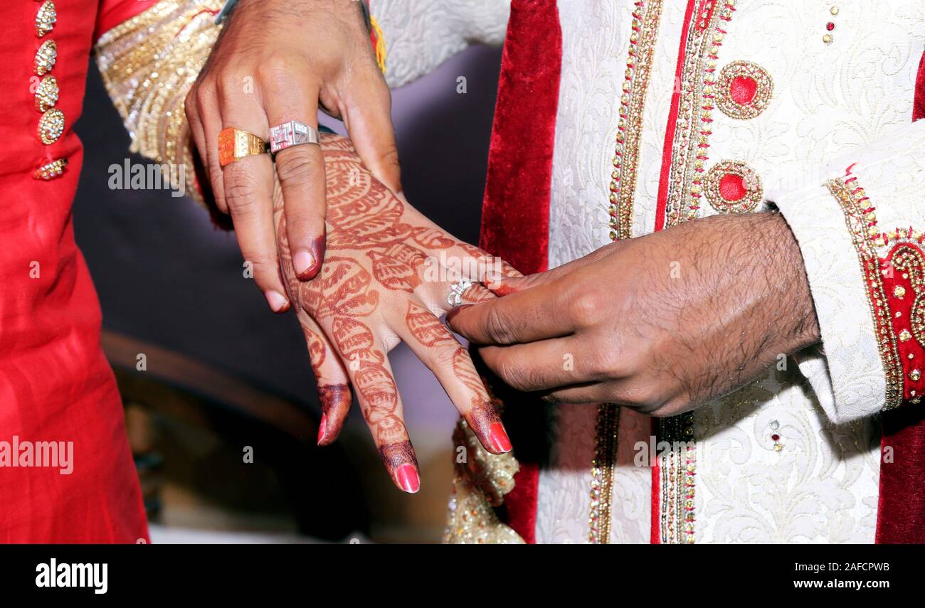 Close Up Picture of Bride and Groom`s Hands Putting on a Wedding Ring at  Official Marriage Ceremony. Bride and Groom are Getting Stock Image - Image  of love, finger: 253272319