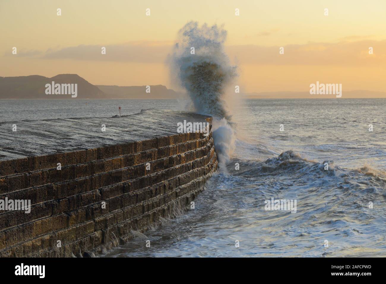 Big waves splashing on the Cobb in Lyme Regis, Dorset caused by gusty