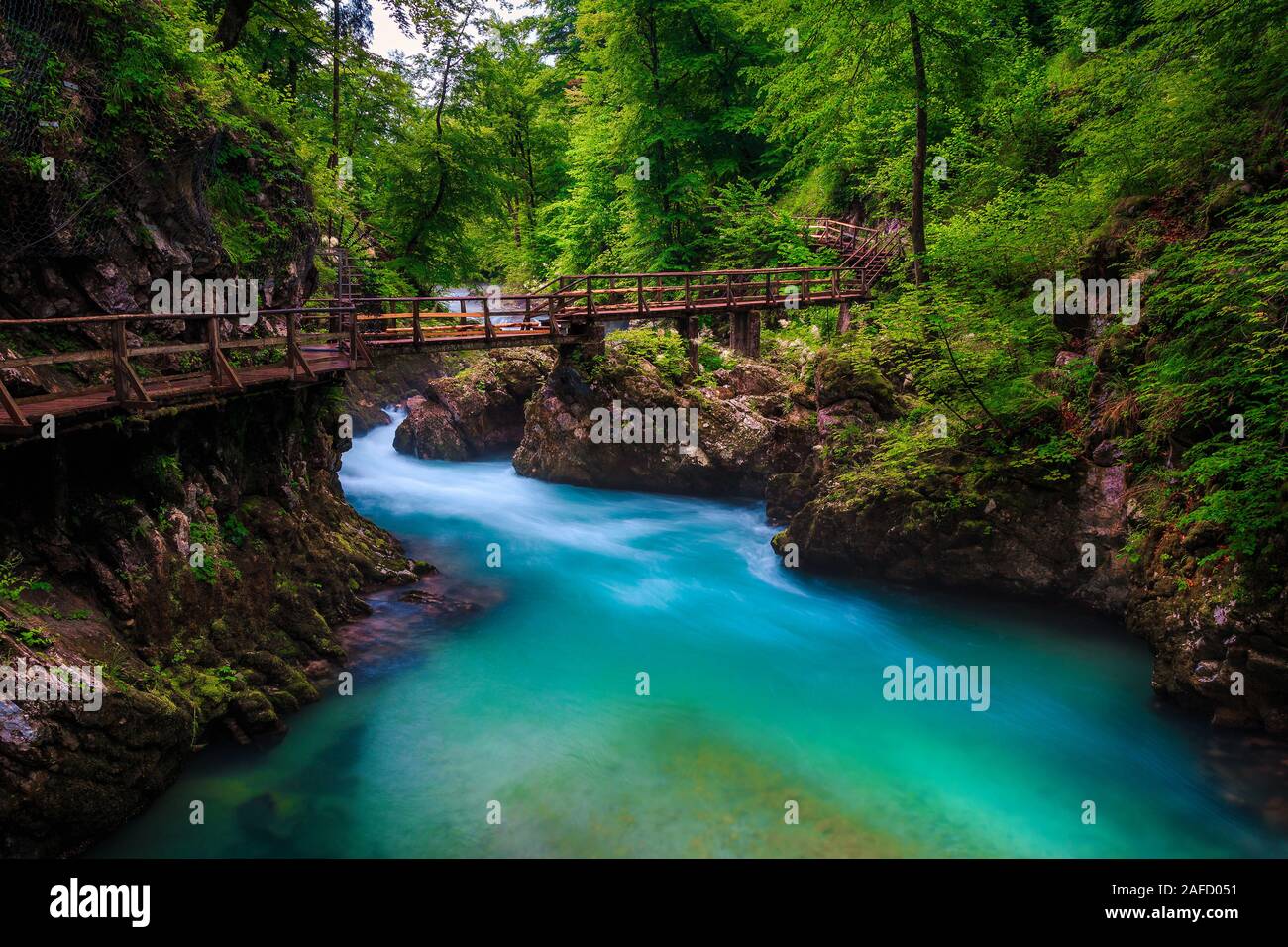Superb and well known touristic location near Bled. Admirable Vintgar gorge with wooden footbridge and emerald color Radovna river, near Bled, Gorje, Stock Photo