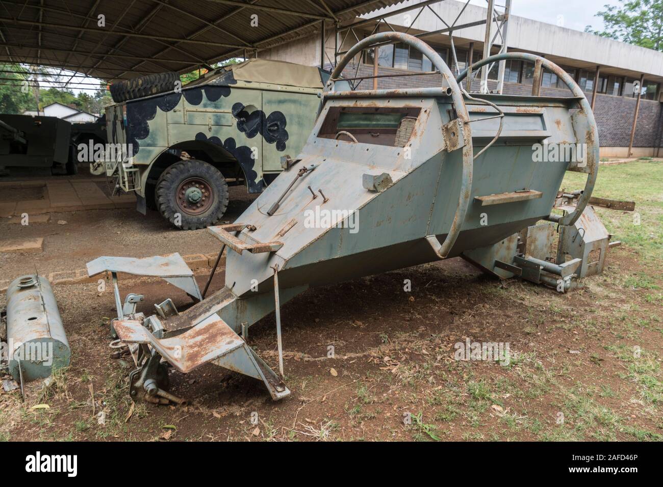 Gweru, Zimbabwe. The military museum. A Rhodesian Army artillery-towing truck (in the background) and the chasis of a 'Leopard' mine protected vehicle. Stock Photo