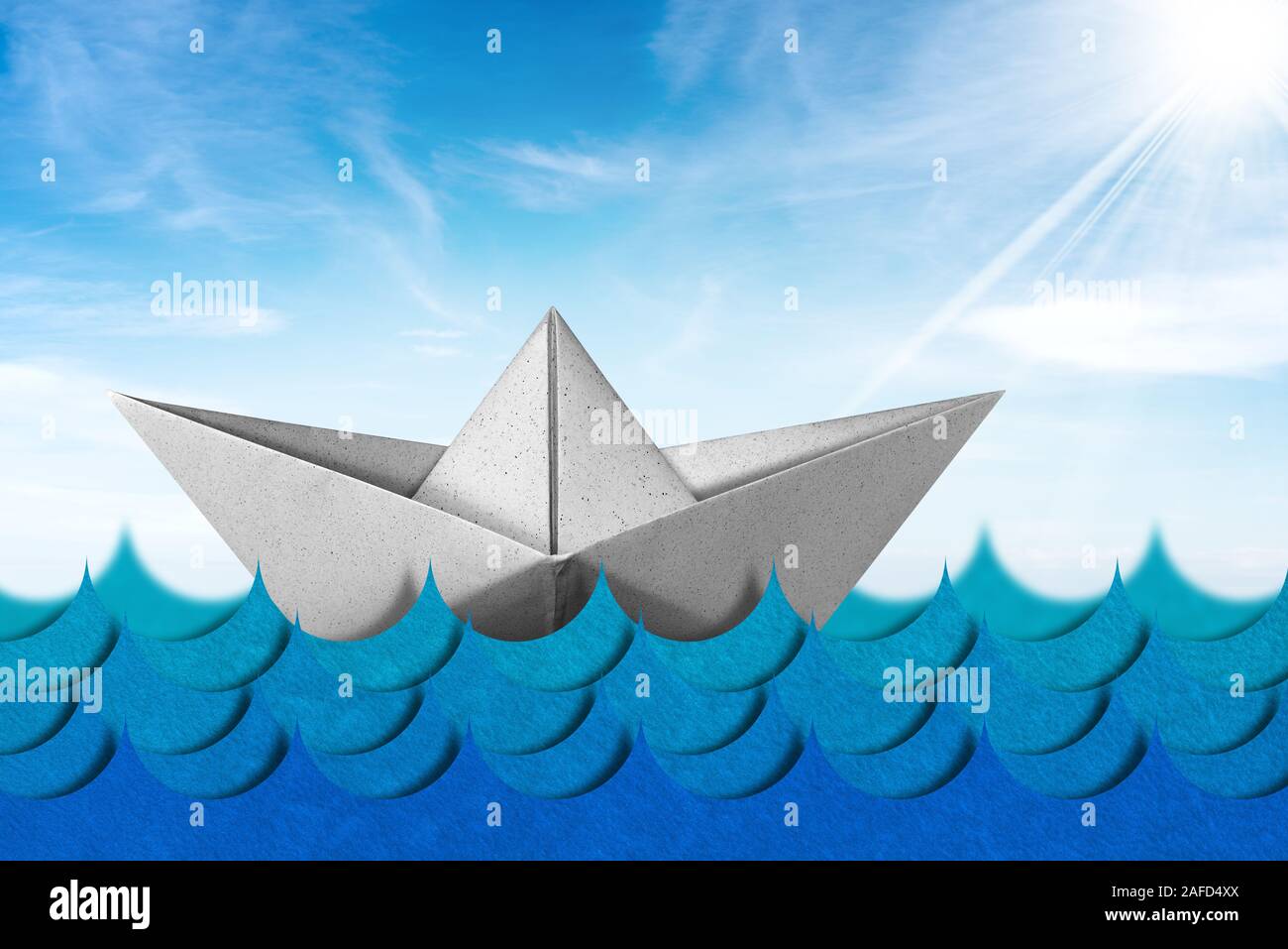 White paper boat in the blue waves of the sea with blue sky, clouds and sun rays, 3d illustration and photography Stock Photo