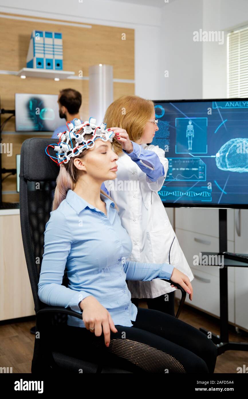 Doctor preparing brain waves scanning headset for tests. Doctor