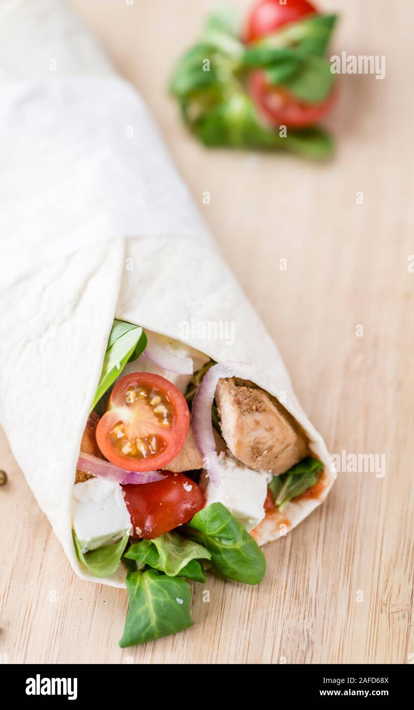 Homemade Chicken Wrap (close-up shot) on vintage background (selective focus) Stock Photo