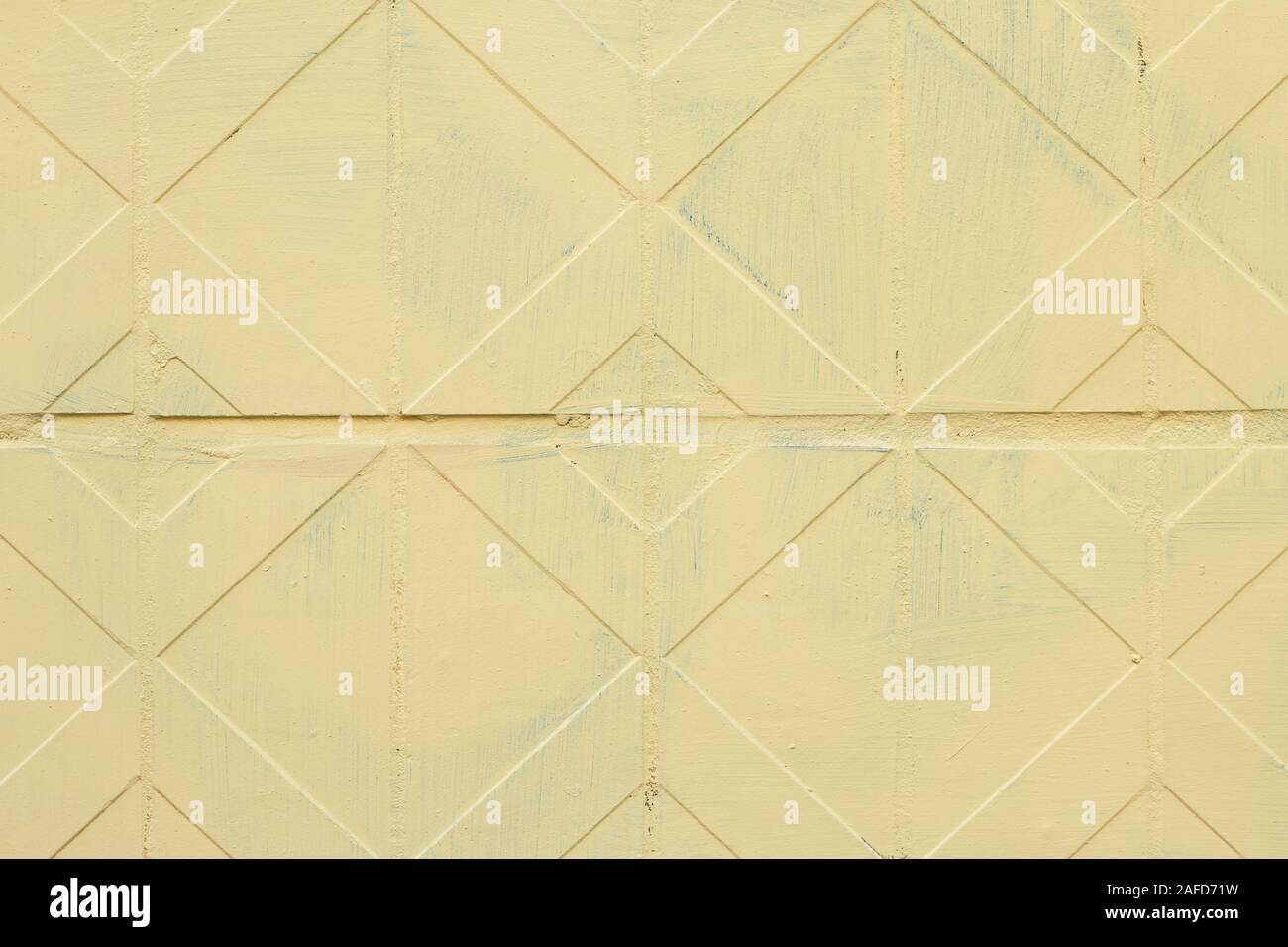 Geometric tile ornament on the wall. Decorative yellow tiles in shape square and rhombus. Vintage facade, background texture, floor pattern Stock Photo