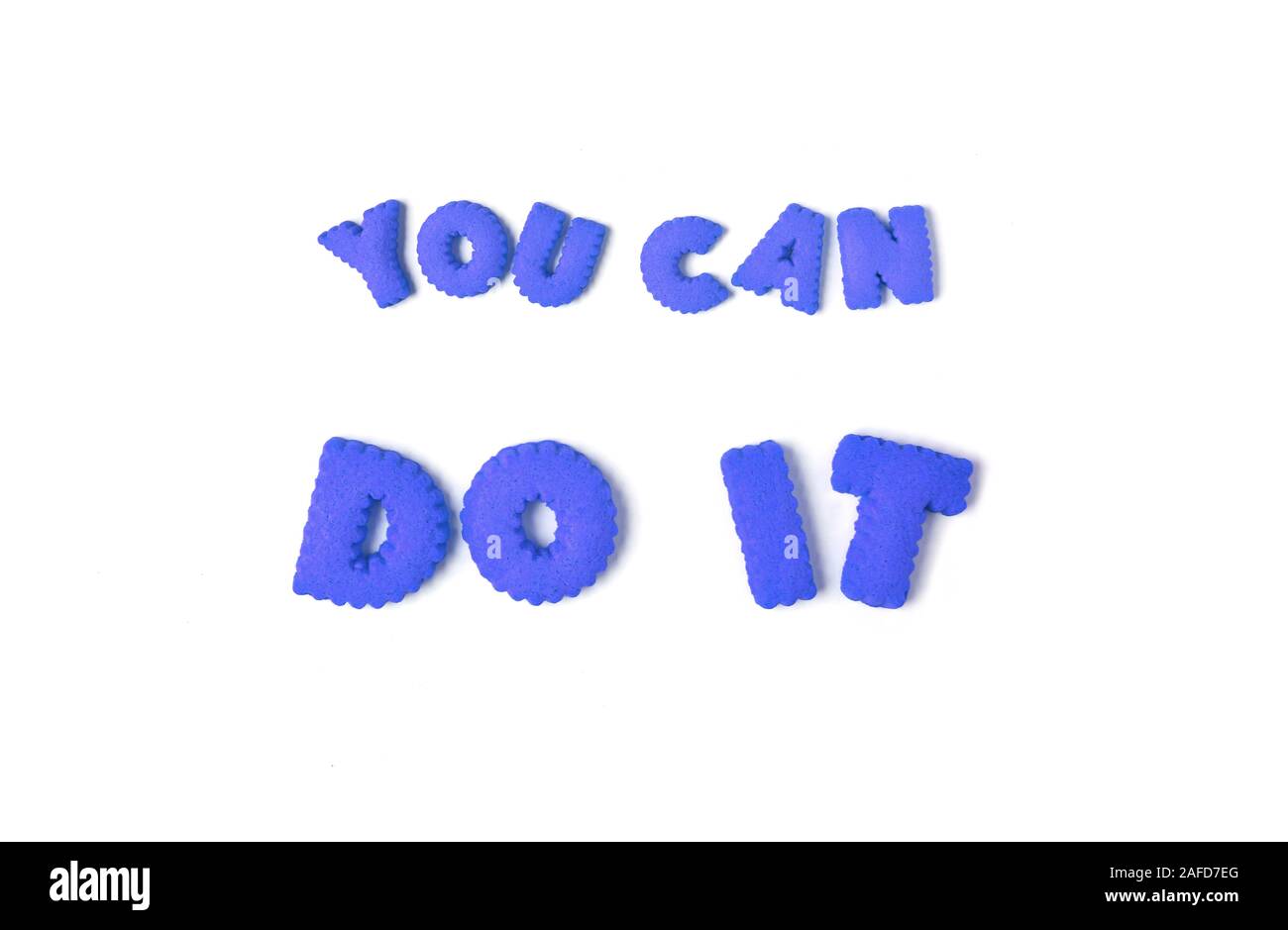The word YOU CAN DO IT spelled with blue alphabet shaped cookies on white background Stock Photo