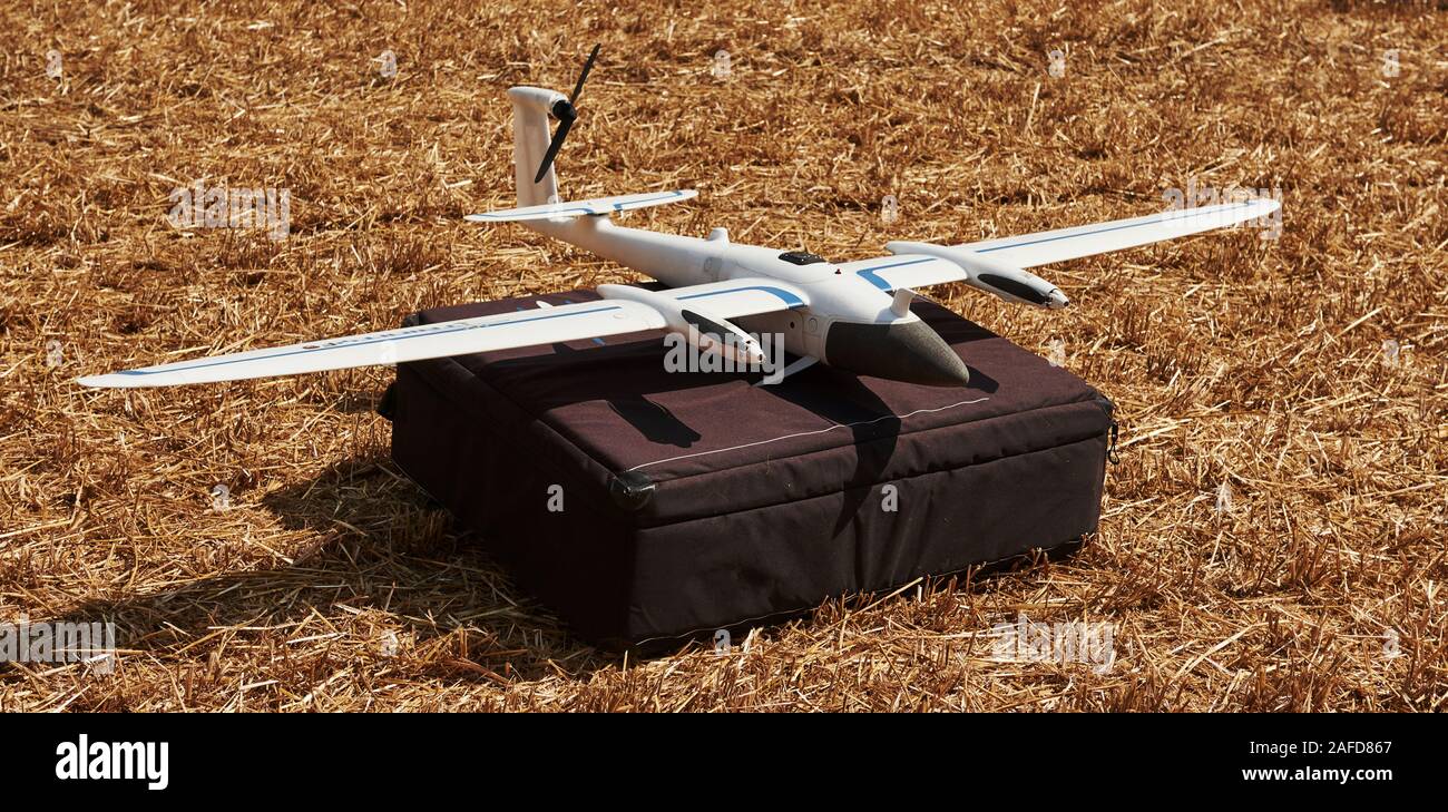 Modern small remote controlled white colored plane on black bag. Ready to fly Stock Photo