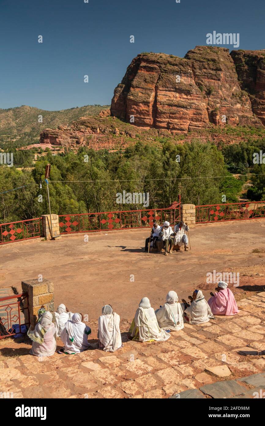 Ethiopia, Tigray, Wukro, Abraha we Atsbeha, C10th church, devotees sat outside after mass Stock Photo