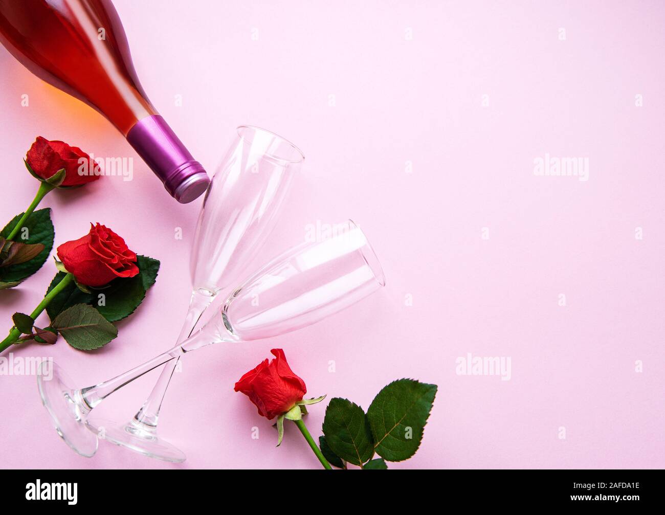 Valentines day greeting card. Red roses, wine and glasses for wine on a ...