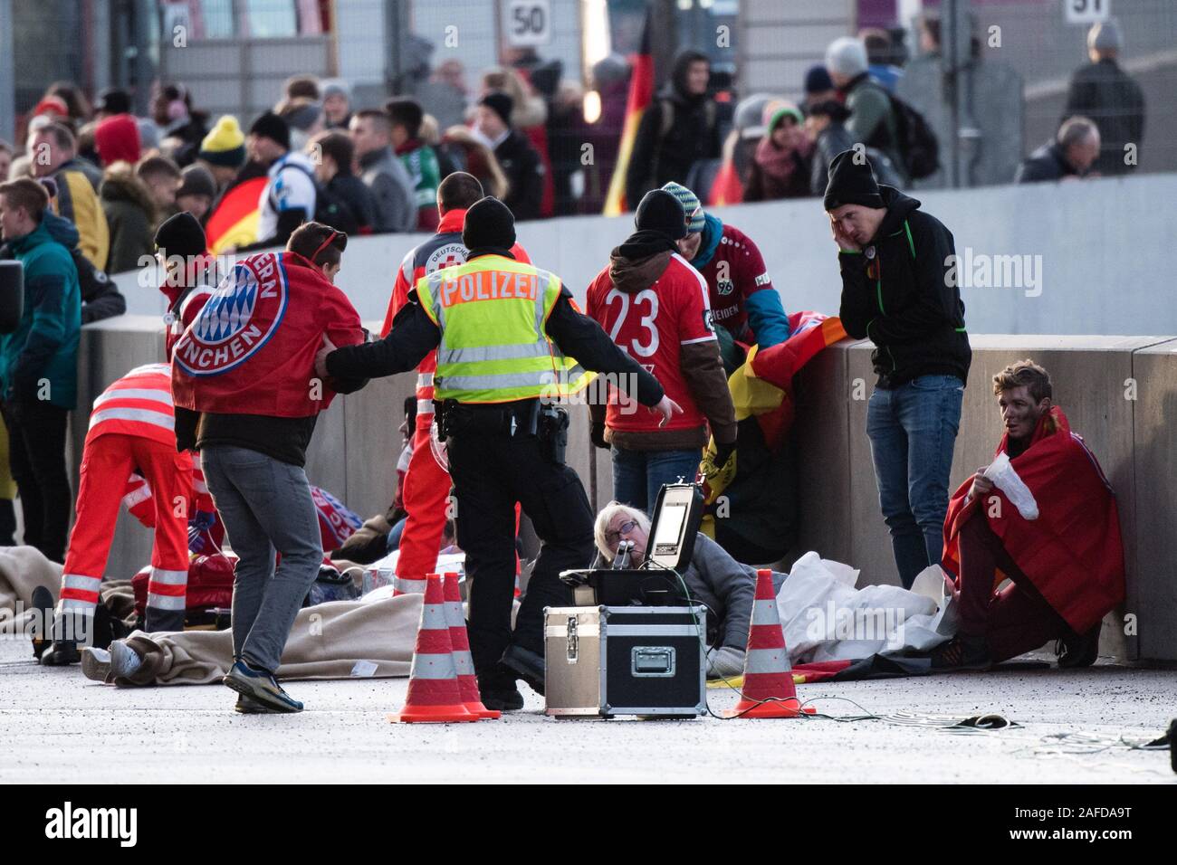 Munich, Germany. 15th Dec, 2019. Injured persons played by extras are gathered together by the police and rescue services in one place during a disaster control exercise for the European Football Championship 2020 in the Allianz Arena. During the exercise, the explosion of a deep fryer in a snack bar inside the arena was simulated with a mass attack of injured persons. The joint disaster control exercise 'EMÜ19' of fire brigade, police, rescue services, the City of Munich and the German Football Association serves to prepare for the UEFA European Championship 2020. Photo: Matthias Balk/dpa Stock Photo