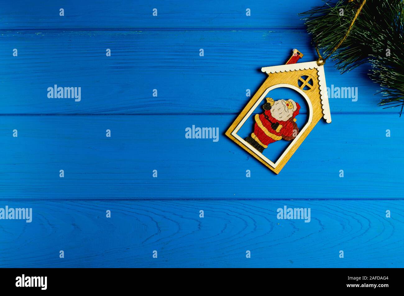 Christmas card: figurine of Santa Claus on a blue background Stock Photo