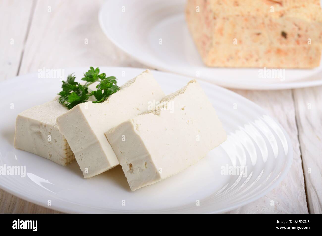 Soy Bean curd tofu on clay dish closeup. Nondairy alternative